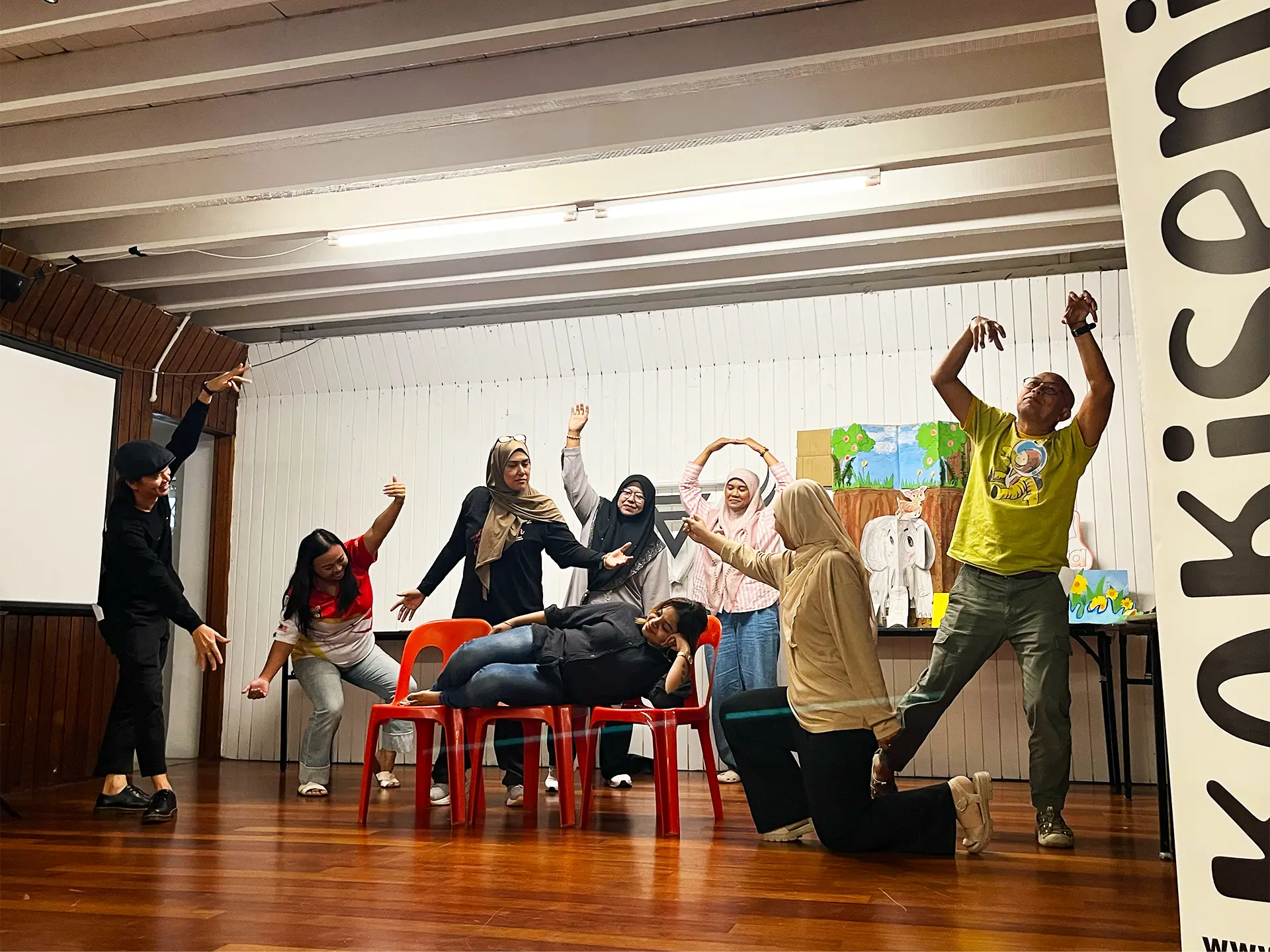 Participants performing a group movement exercise on stage