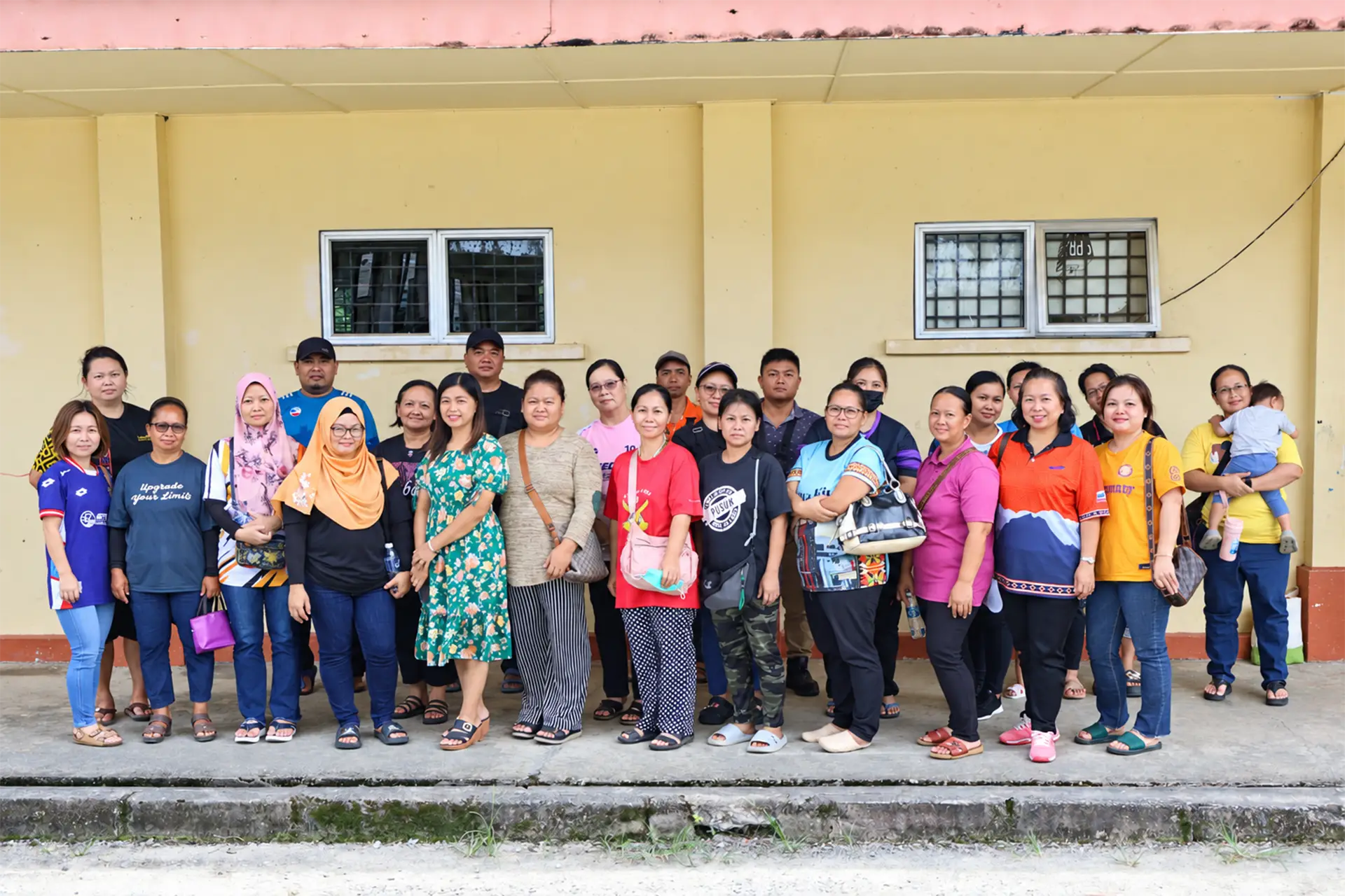 Community members gathered for a group photograph outside a building