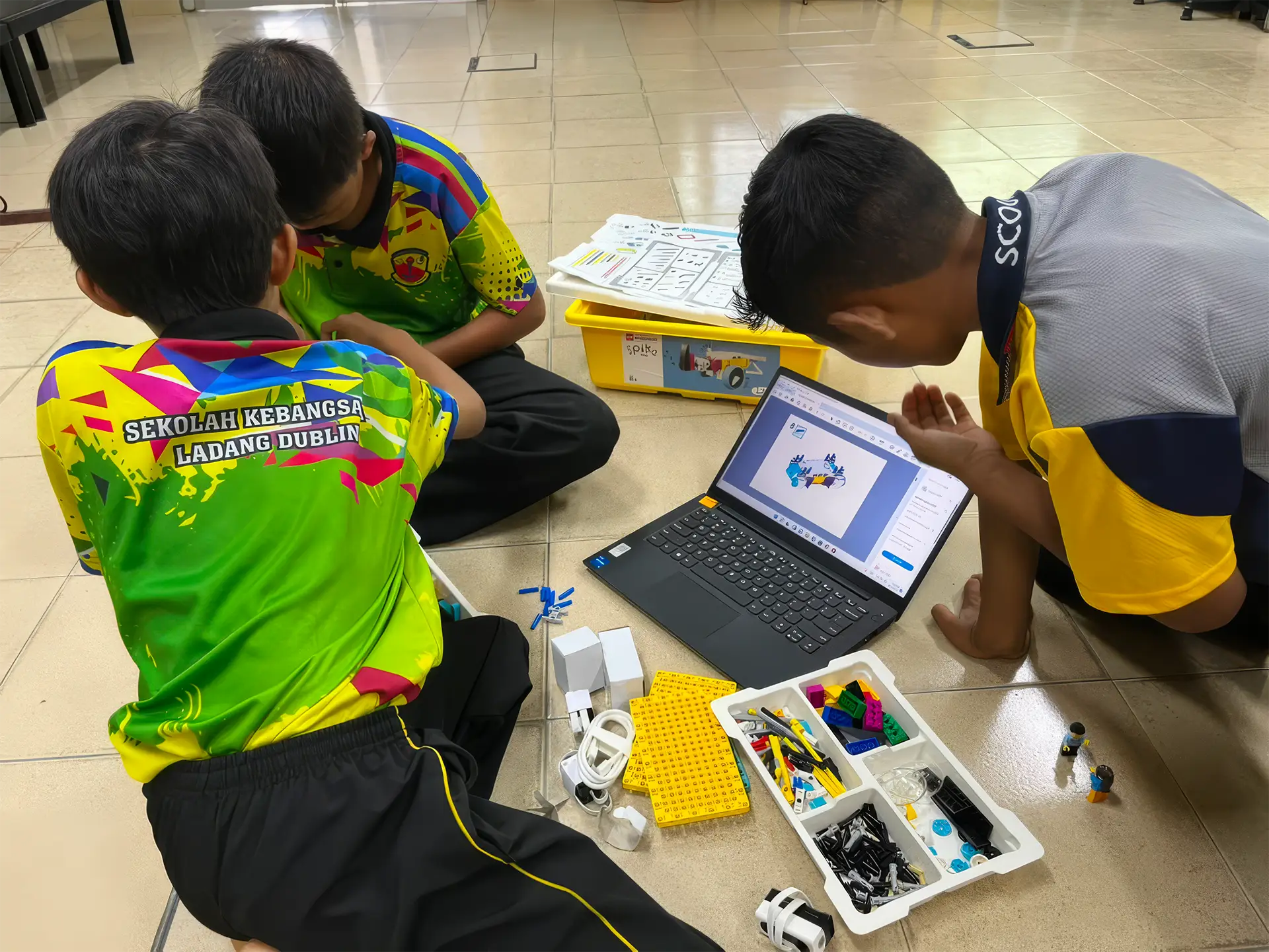 Students using a laptop during a robotics activity